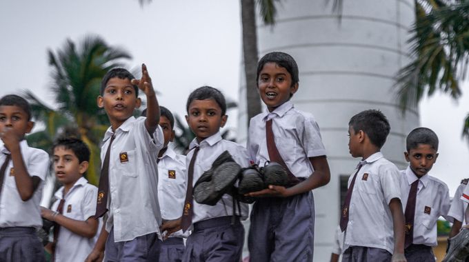 Schoolchildren in uniform outside a village school in Sri Lanka