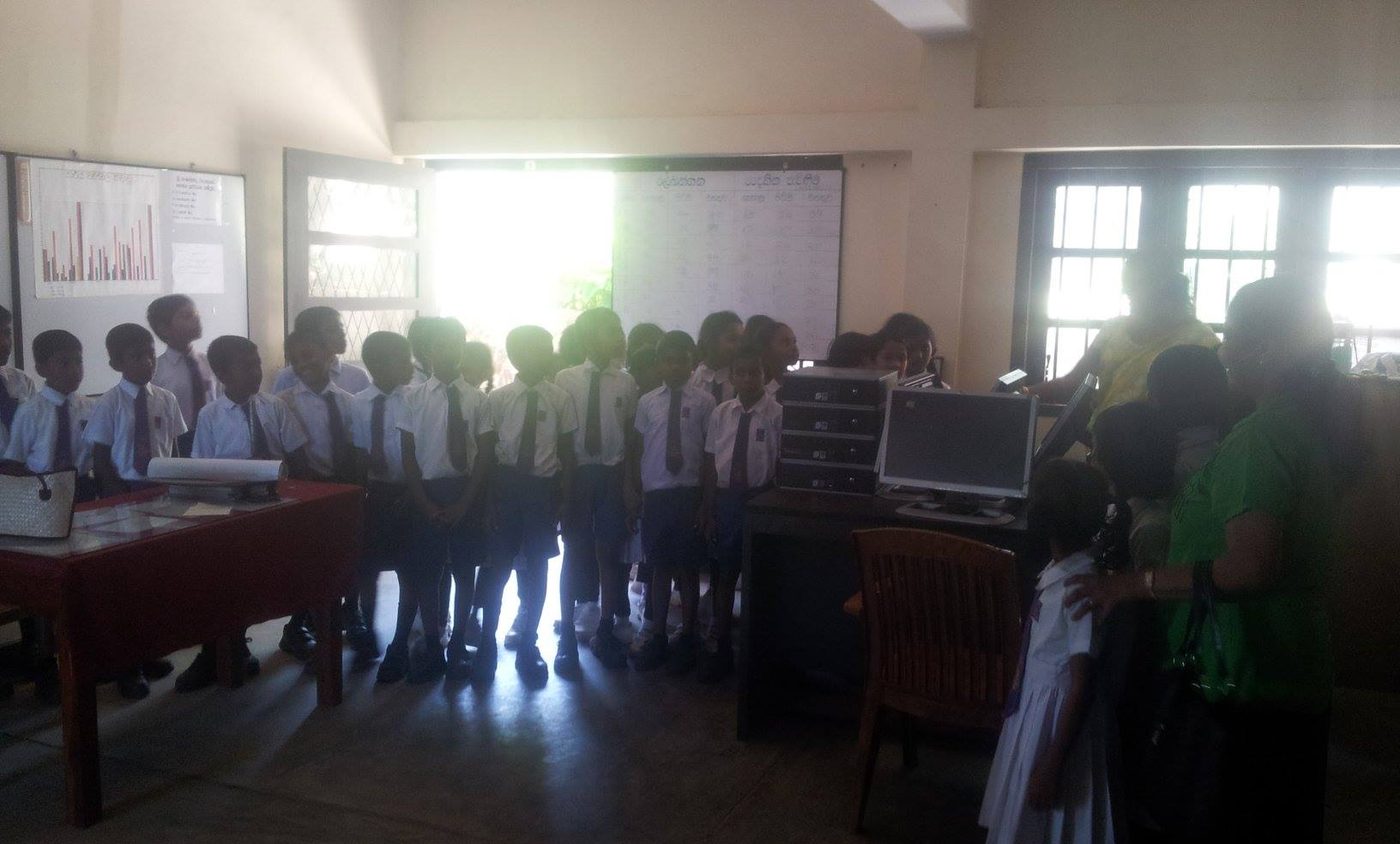 Students at a village school in southern Sri Lanka beside newly installed computers